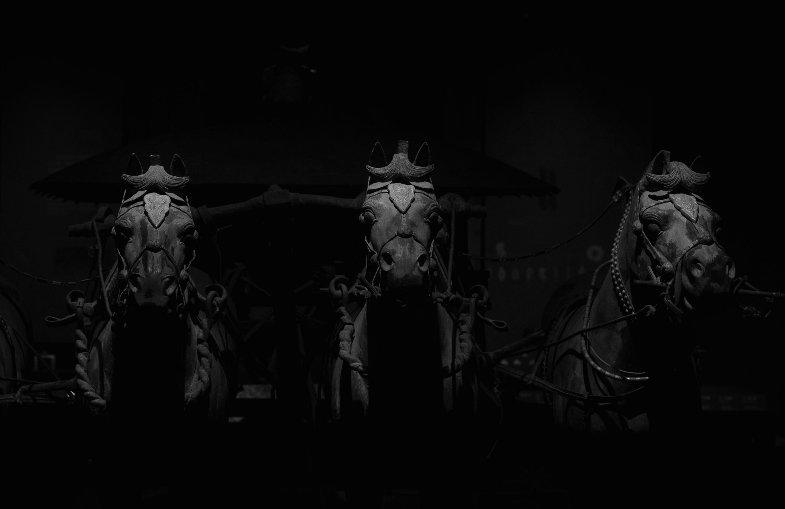 Three horses emerging from the darkness symbolize the hidden threats that can quietly undermine a Generative Engine Optimization (GEO) program, including organizational silos, lack of curiosity, and underinvestment.