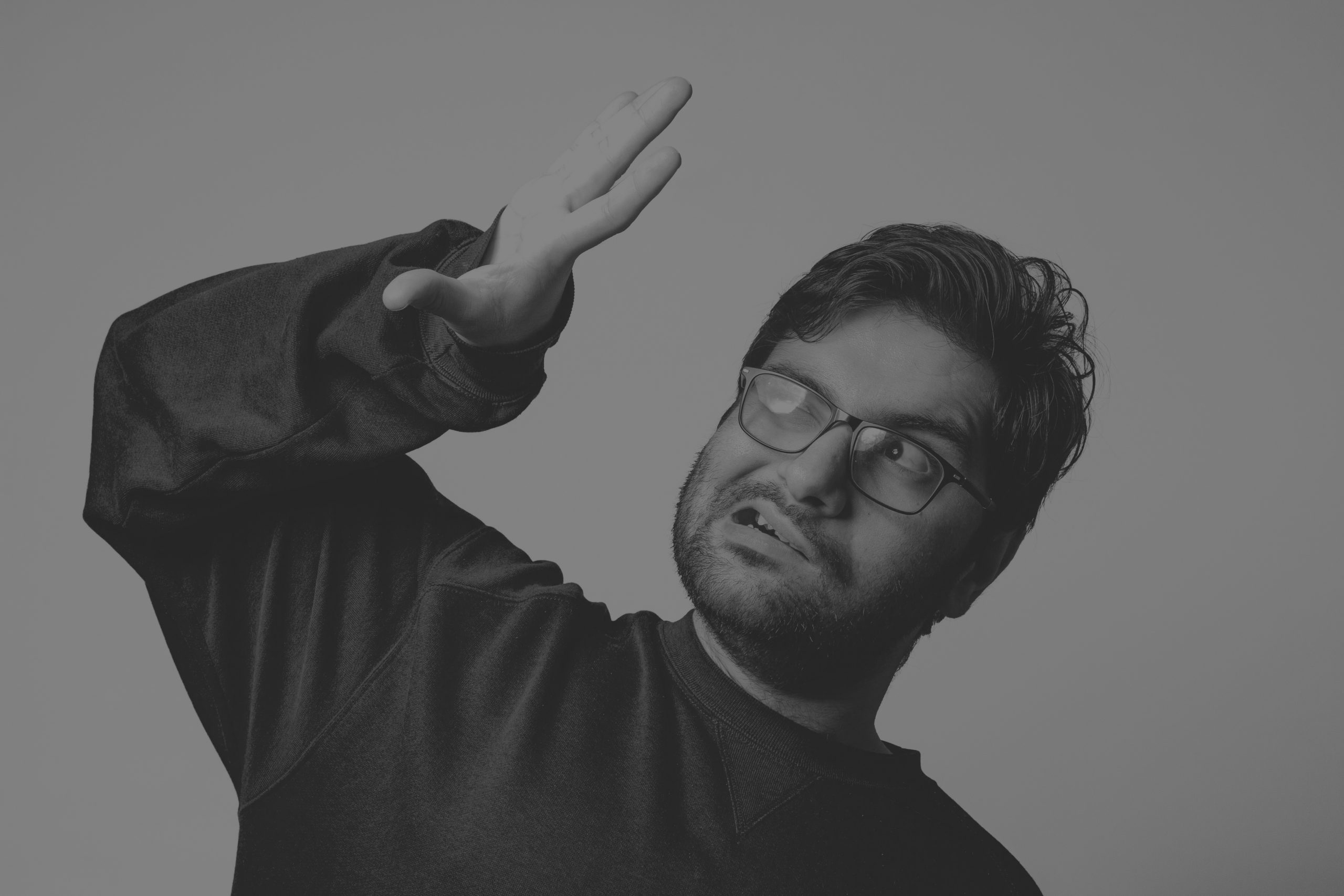 Black-and-white image of a man shielding his eyes from bright light, illustrating how real-world GEO data can challenge assumptions about AI recency bias and content freshness.