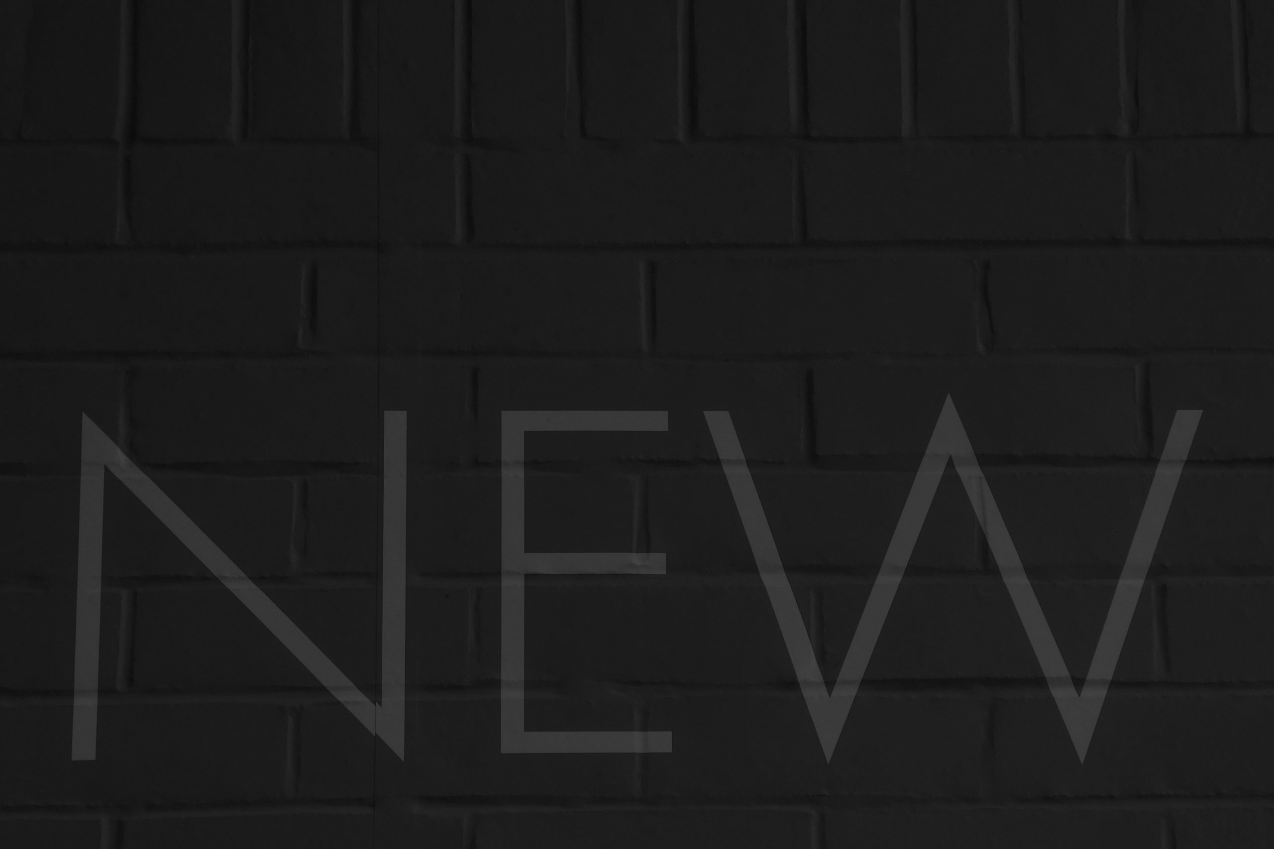 Black-and-white image of the word “NEW,” representing how consumer tech brands use PR, positioning and storytelling to create and own new product categories.