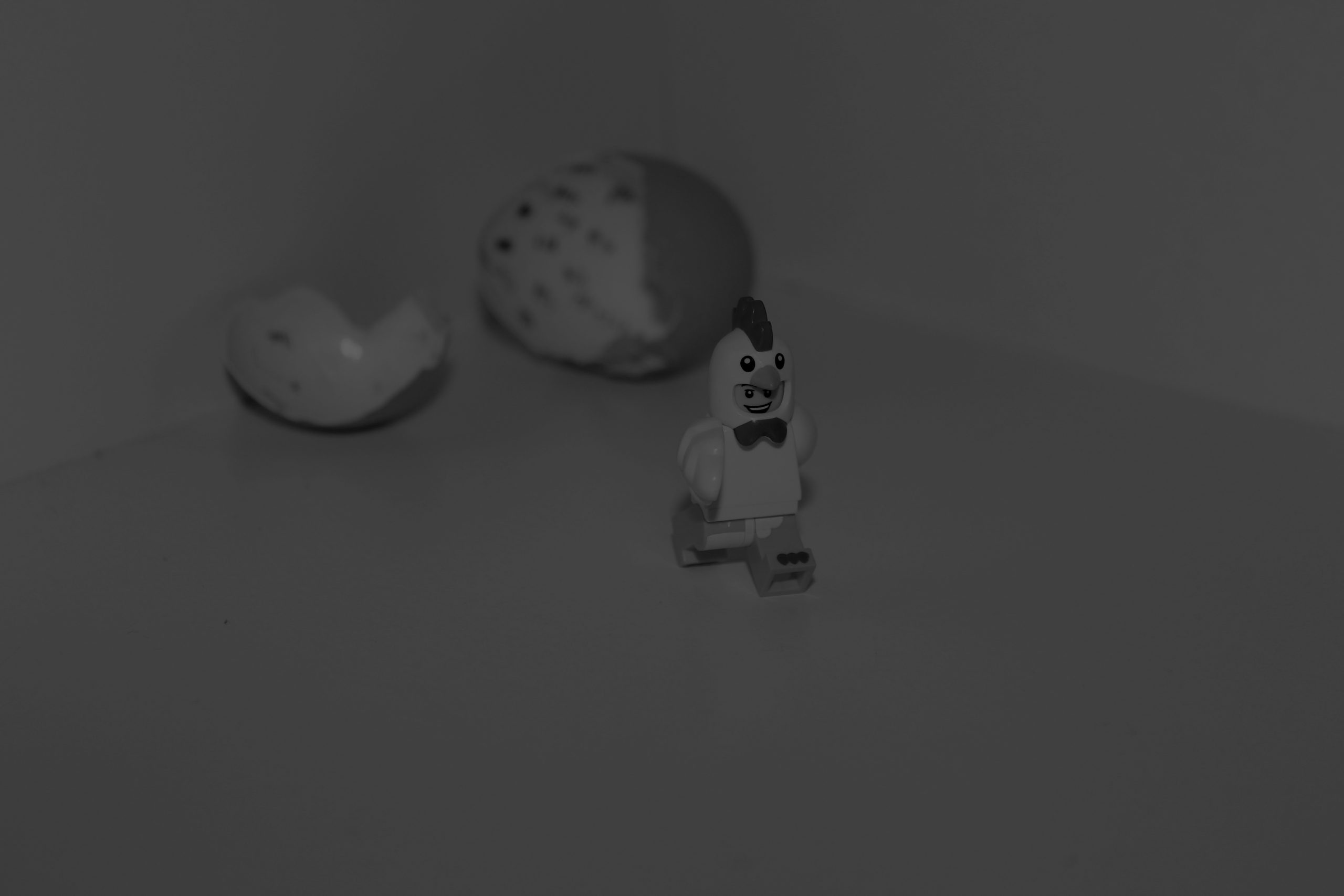 Black-and-white image of a LEGO figure beside a broken egg, representing the question of who should own GEO across PR, SEO and content teams.